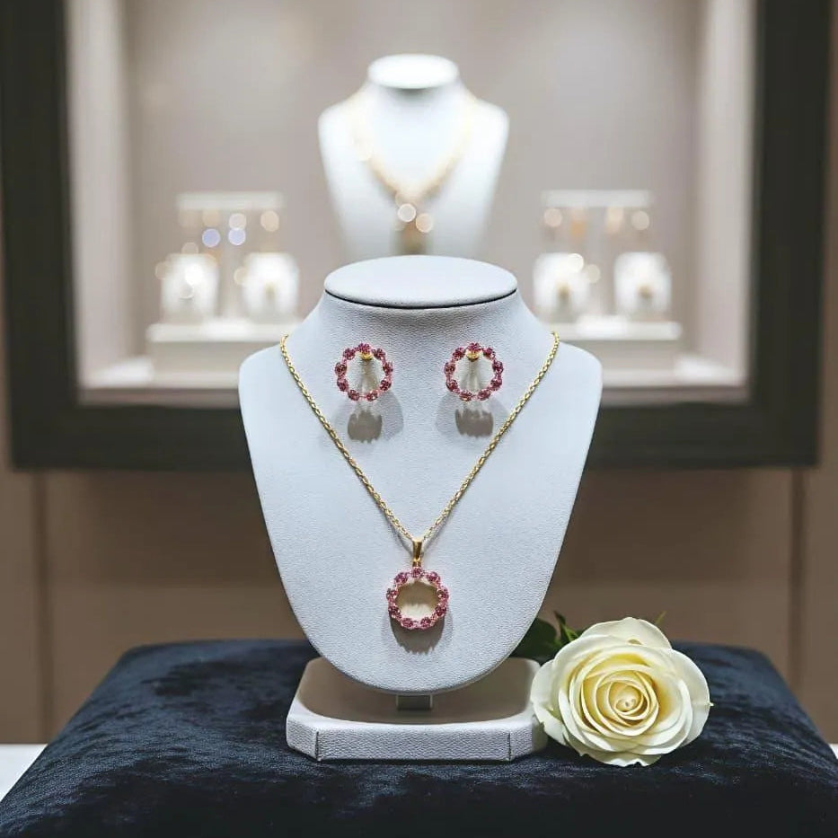 Jewelry set on a white stand with a flower on a dark surface, blurred jewelry store background