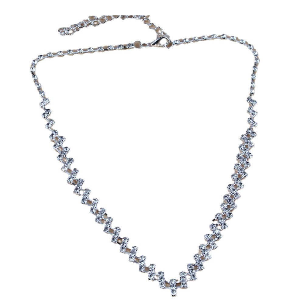 Silver necklace with clear stones on a white background