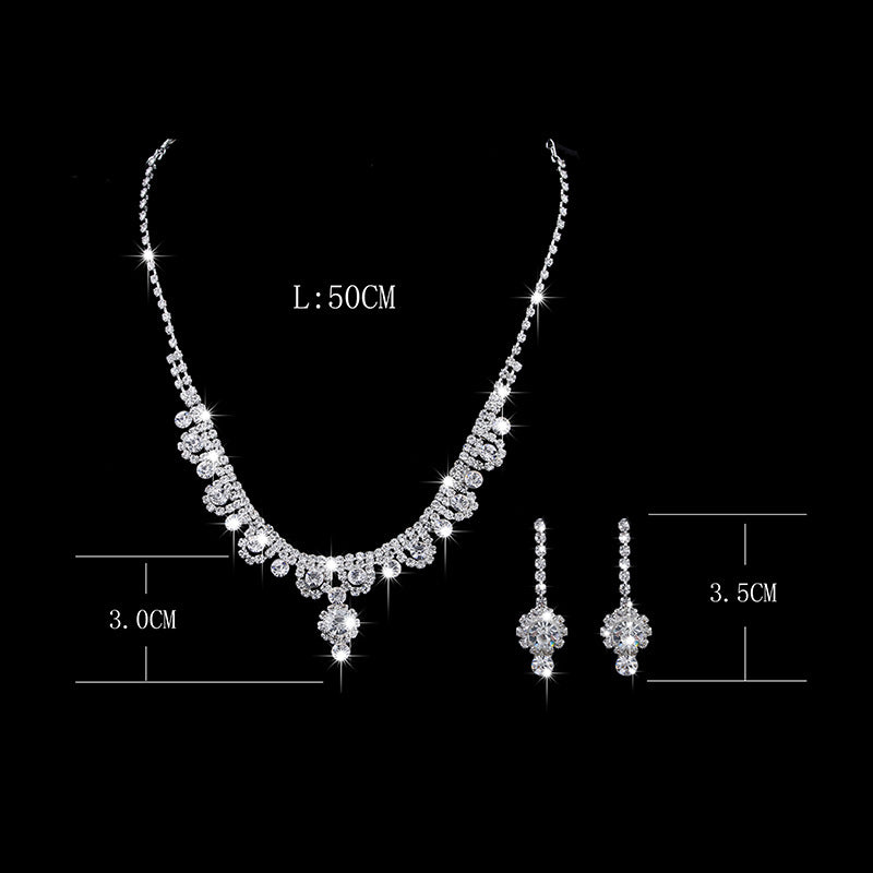 Silver necklace and earrings set with measurements on a black background
