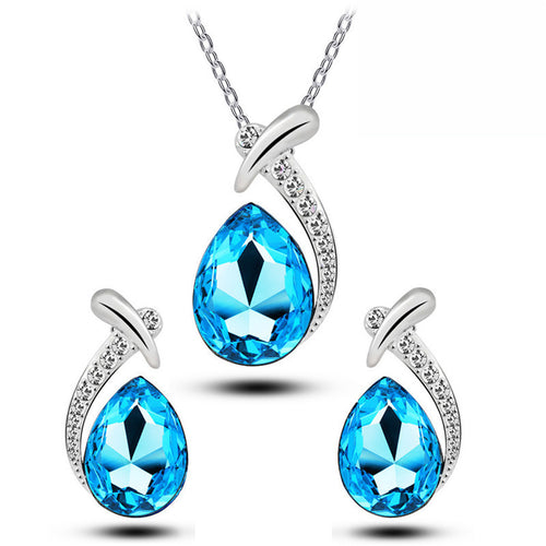 Jewelry set with blue teardrop-shaped gemstones and silver accents on a white background