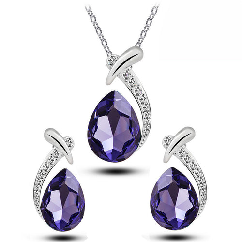 Jewelry set with purple teardrop-shaped gemstones and silver accents on a white background
